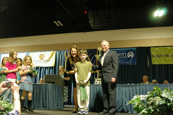 In February, Capt. Slevin (r) helps to recognize participants of the Hillsborough Regional STEM Fair. 